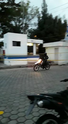 Police Officer Riding Motorcycle in Urban Environment