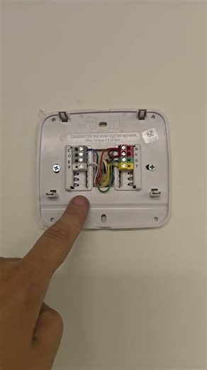 hvac technician goes over professional installation of a thermostat