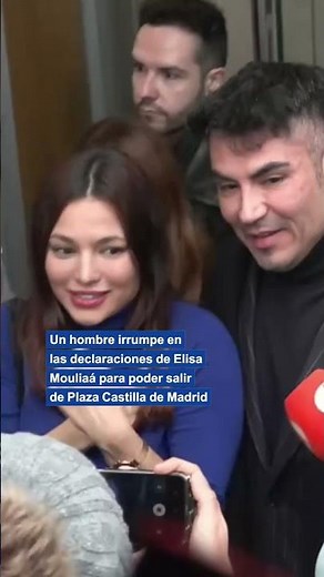A man angrily interrupts Elisa Mouliaá's statement in order to leave the courthouse.