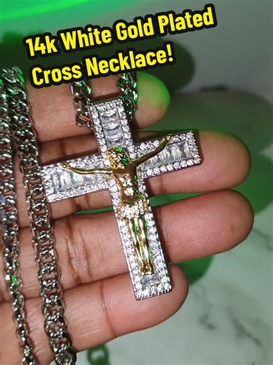 Vogcome 14 Karat White Gold Plated Cross Necklace is a bold 24 inch necklace designed to shine with confidence and lasting quality, crafted to resist fading, discoloration, and turning your skin green so you can wear it every day without worry. This large oversized men's cross necklace features a brilliant iced-out crucifix design with a detailed gold-tone center set against a sparkling white gold plated finish, creating a powerful statement piece that instantly elevates your style. Whether you 