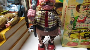 Pistol Pete Tin Battery Operated Toy Boxed Near Mint Working 50s-60s Japan Rare Toy. Here is a grand old toy that you rarely see called Pistol Pete in the box in Near mint condition. He is a big tin toy at 11 inches tall. On the remote there are two settings one to make him walk and the other to make him simulate shooting. All of these work great. Last year was the last time I tried him and the smoke feature was there but, faint. Now I don't see any. Maybe more running time is needed or a drop o