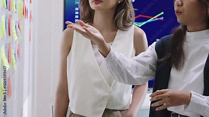 brainstorming session, using sticky notes on a task board (kanban) to organize ideas and workflow in a modern office