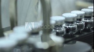 Pharma manufacturing vaccine injection manufacturing line glass vial bottle on a conveyor belt in a Pharma production factory injections in large vials factory process with latest hi tech machinery