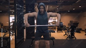 Man Doing Wide Grip Upright Row Exercise in Bent Position for Rear and Mid Delt Muscles Training at Indoor Gym - front view