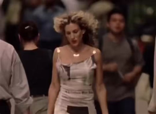Carrie Bradshaw, Sarah Jessica Parker walking solo in newspaper dress in slow motion New York City cars curly hair blowing in the wind enlightened refreshed relieved free contempt ratchet Lorde buzzcut season Sex and the City reaction video meme