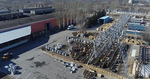 Electric cable manufacturing plant, outside. Open storage warehouse for large wooden drums of power cable. Storage yard of the plant from above.
