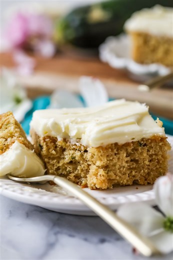 Richly flavored with brown sugar and vanilla, my zucchini cake recipe makes eating your veggies a delight! We spread a smooth, cream cheese frosting overtop for a sweet finish. | Sugar Spun Run