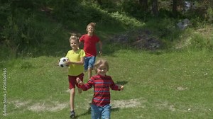 Happy boys runing on a Sunny summer day. Slow motion. Children playing Outside. The concept of friendship, peace, kindness, childhood.