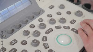 Doctor setting up an ultrasound machine at a medical center.