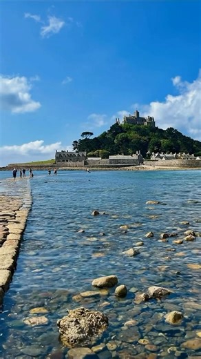 St Michael’s Mount in Cornwall is a tidal island with a medieval castle on top, where you can walk across the causeway at low tide and watch the sea surround it again. #travel #cornwall | UK Hidden Gems