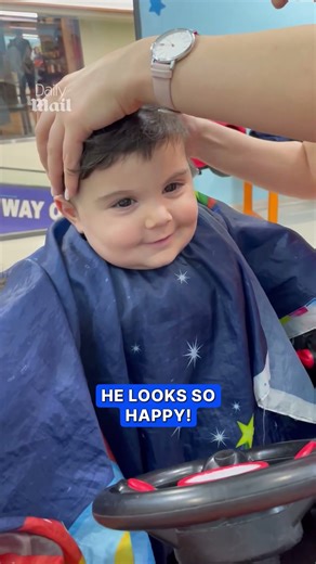 Kid can’t stop smiling while getting haircut