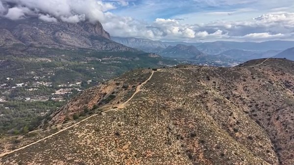 Mountain trail winding along ridge under cloud deck, ranger patrol perspective with rugged path, sweeping Stock Video Footage - Alamy