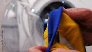 Analyzing the label with cleaning instructions before putting the clothes into a washing machine