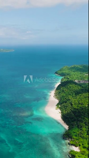 White sandy beach with turquoise clear waters in Puka Shell Beach in Boracay Island. Philippines. Vertical view.