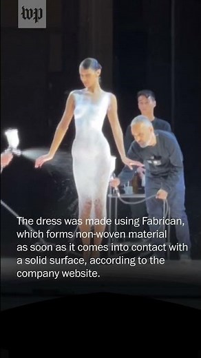 Bella Hadid gets a spray-on dress during Paris show