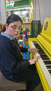 Isa at her favourite motorway services with a yellow piano. Entertaining everyone there.