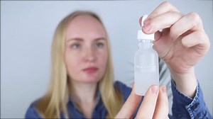 Niacinamide. Girl applies vitamin b3 to her face. Laboratory research. Skincare. Dermatological serum. Emulsion for narrowing of pores, normalization of sebum production and lightening of pigmentation