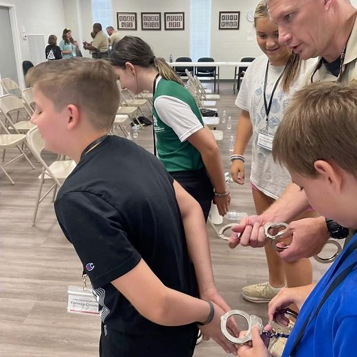Kids trying on handcuffs!