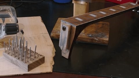 clip-4016184291-pan-across-workbench-frets-neck-acoustic-guitar