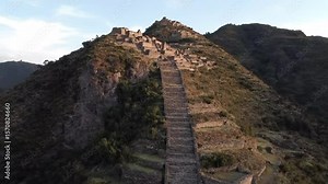 Ancient inca ruins cascade down a mountain in peru, a testament to south americas rich history