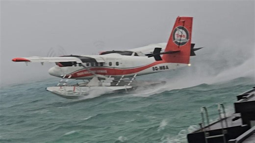 Sea plane battered by wind while taking off in choppy sea