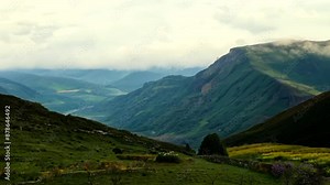 This breathtaking scene captures the stunning landscape in the mountains of Wales. Rolling green hills, rugged peaks, and serene valleys create a picturesque view, showcasing the natural beauty