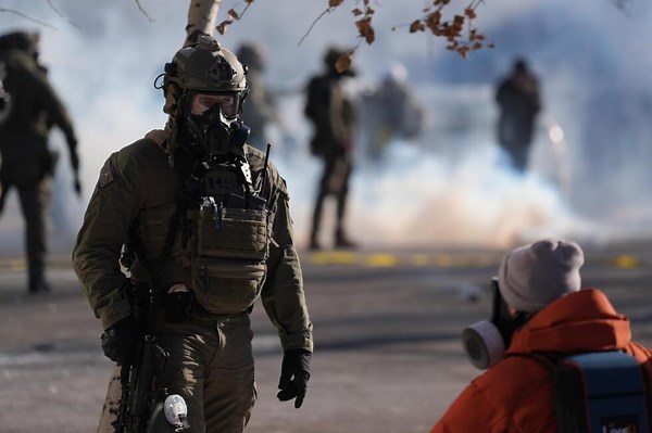 Federal agents deploy tear gas at crowd gathered at scene of deadly shooting in Minneapolis