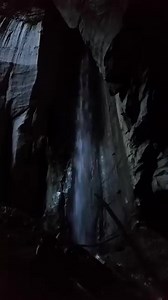 An underground waterfall hidden inside a Tennessee cave. The water slips in from the surface and disappears just as quickly, just a fleeting glimpse as it passes through. #Tennessee #waterfall | TAG Caver