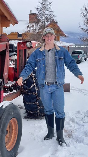 Snow Plowing with Chained Tractor on the Farm