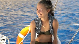 Happy teenage girl relaxing on boat while sailing on sea, super slow motion 240fps