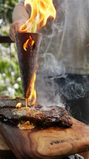 OZ Braai on Instagram: "Nothing sparks a reaction like the Flambadou 🔥. One butter cube and the flames explode into the kind of moment everyone wants to film. #FlambadouCooking #LiveFireFood #AussieBBQ"
