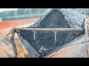 The Process Of Unloading Sand From A Cargo Barge