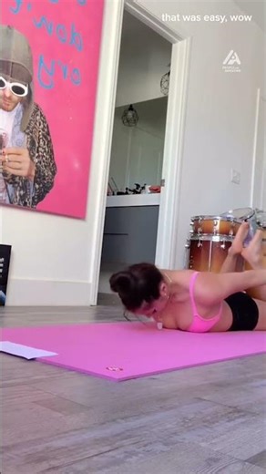 Woman Picks Up Objects From Floor While Performing Yoga
