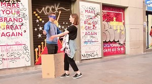 Blindfolded man gives free hugs to passersby in Madrid streets