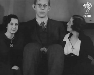Footage from 1936 shows the tallest man to ever live, Robert Wadlow. Robert passed away in July 1940 due to complications from a faulty leg brace that caused irritation and infection in his ankle. Despite receiving treatment including a blood transfusion and surgery, his condition deteriorated further due to an autoimmune disease. He passed away in his sleep on July 15. At the time of his death he measured 8 ft 11.1 in tall. His coffin was 10 feet 9 inches long and weighed over 1,000 pounds. It 
