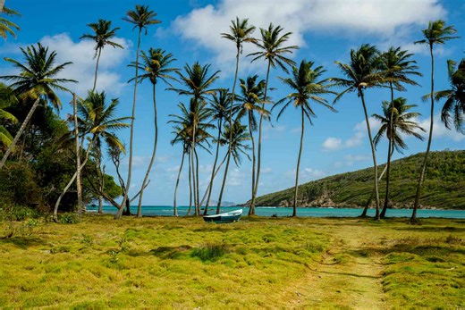 This Tiny Caribbean Island Has Pristine Beaches and a Floating Bar—and You Can Drive Across It in Under 30 Minutes