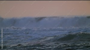 This super slow motion video shows a close up view of choppy ocean water and crashing waves.