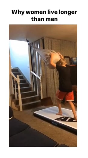 memes.90 on Instagram: "The post features a 16-second video of a young boy swinging from a makeshift rope onto an inflatable mat in a living room, accidentally igniting a fire on the landing spot, captioned "Why women live longer than men" to highlight risky male behaviour in a humorous way. Posted by , an account sharing ironic and wholesome clips of men's antics, this content exploded to over 6.5 million views and 10,000 likes within two days, sparking replies joking about parental repercussio