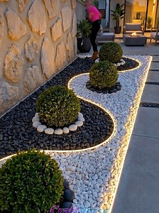 Modern Stone Garden Glow: Sleek Backyard Lighting & Design