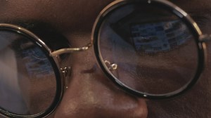 Reflection in the glasses of a man using a tablet - Free Stock Video