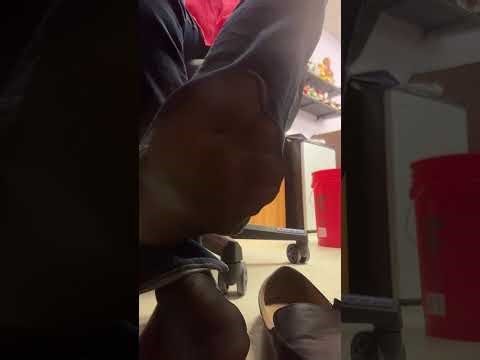 Under desk shoe play in her classroom. Sweaty nylons and black flats.