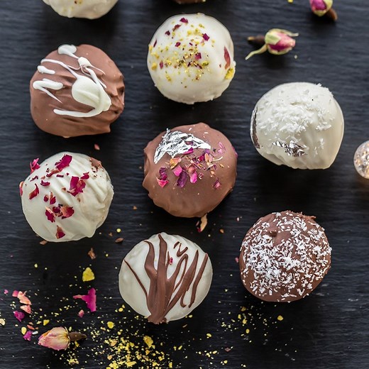 NEW! Burfi Truffles- inspired by the plain old burfi, these truffles are made with milk powder and dipped in dark and white chocolate! 😋 Garnished with crushed nuts, rose petals, desiccated coconut, edible silver leaves, these make the perfect edible gifts for friends & family for the festive season! 🙌 Make them for Diwali! Full recipe: https://www.cookwithmanali.com/burfi-truffles/ | Cook with Manali