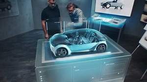 Two automotive engineers develop body of new eco-friendly electric car using futuristic augmented reality holographic automobile prototype. 3D graphics of vehicle high-tech developing. VFX animation.