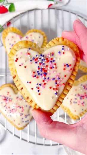 The cutest little Valentine cherry pop tarts you ever did see! ❤️ My daughter, Savannah, made these. Didn’t she do a great job! 💕Comment CUTE & I’ll send ya the recipe.#valentinetreats #poptarts #heartshapedfood #cherrypoptartshttps://www.momlovesbaking.com/best-homemade-frosted-cherry-pop-tarts-recipe/ | Mom Loves Baking