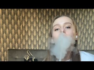 beautiful girl smokes hookah enjoys it and coughs