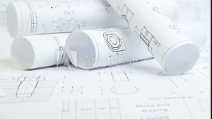 paper engineering drawings of industrial parts and mechanisms