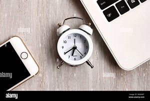 Home office concept. Laptop, notebook, smartphone, , clock, on white wooden table background Stock Photo - Alamy