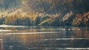 Autumn fly fishing. Amateur fisherman casts the fly in slow motion
