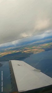 jet wing view flying into clouds layer lake sea background departure take off from airport