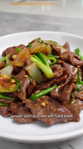 You gotta try this Ginger Spring Onion Stir Fried Beef. It is incredibly tender and juicy, perfect with a bowl of steamed rice. Ingredients 300g beef, sliced 30g ginger, thinly sliced 3 spring onions, white part 4 cloves garlic, minced ½ yellow onion, wedged Marinade 1 tbsp soy sauce 1 tbsp oyster sauce 1 tsp sesame oil Some white pepper 1 ½ tbsp cornstarch Sauce 1 tbsp soy sauce 1 tbsp oyster sauce 3 tbsp cooking wine Some white pepper 1/8 cup of water 1. Marinate the Beef: Mix with soy sauce, 